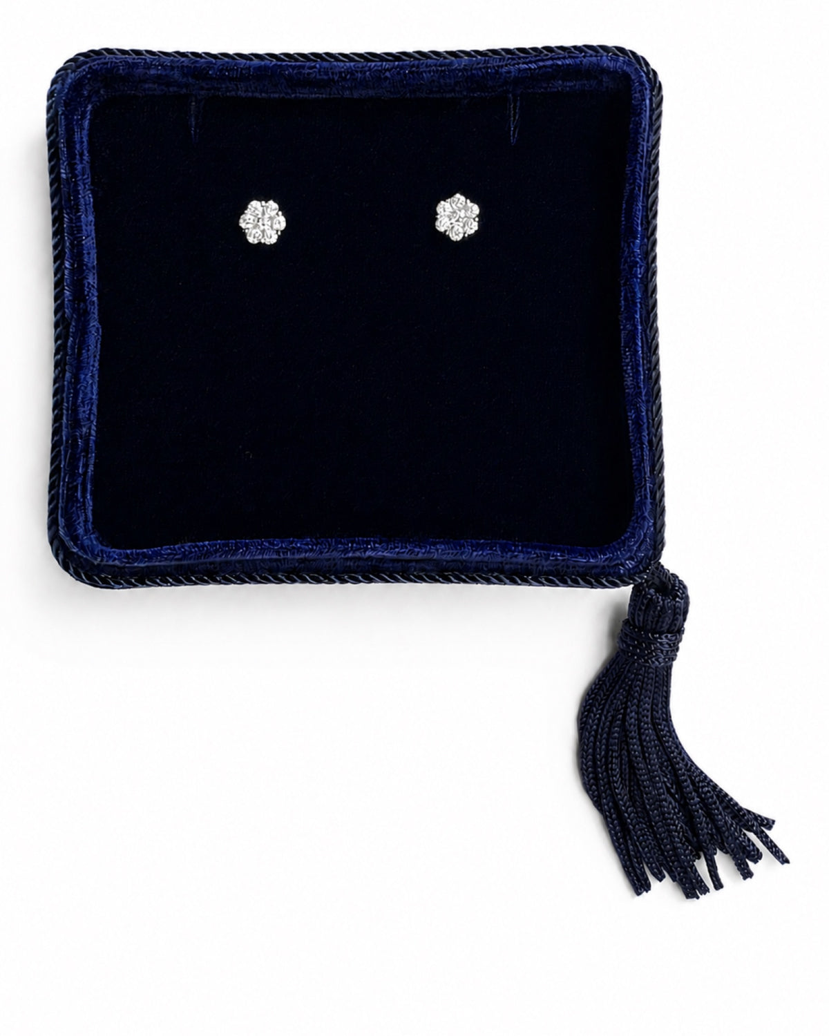 14k white gold diamond flower cluster stud earrings displayed in a navy blue velvet jewelry box. 