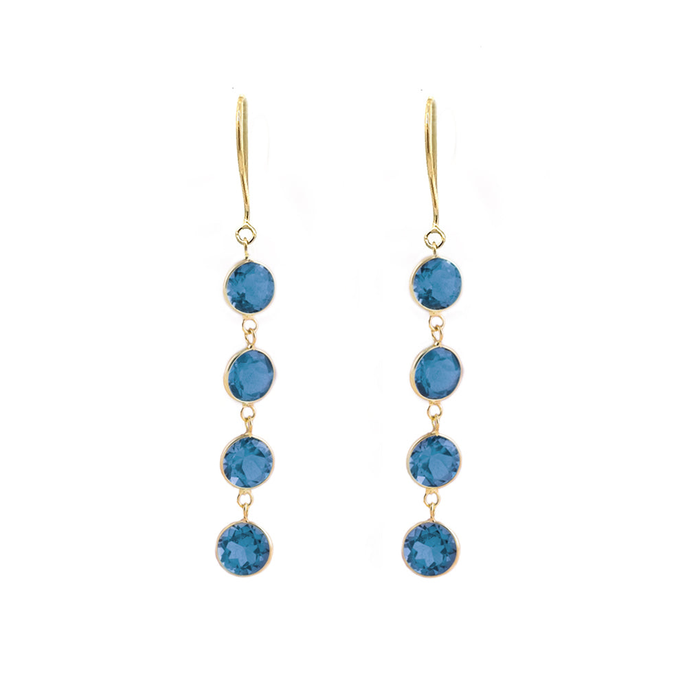 A pair of 18K yellow gold earrings featuring four London Blue Topaz stones each, arranged in a vertical line, creating a drop earrings design.