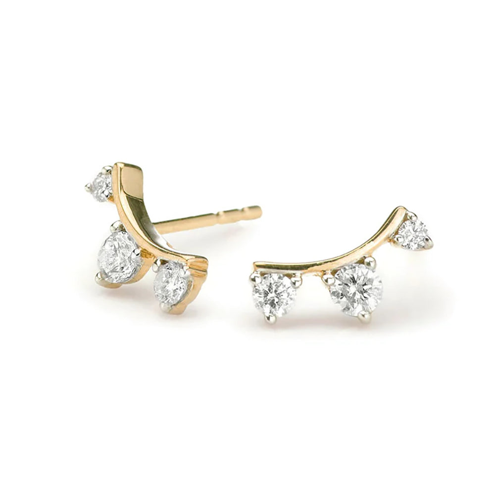 A pair of 14K yellow gold curved post earrings with three sparkling diamonds set along the curve.