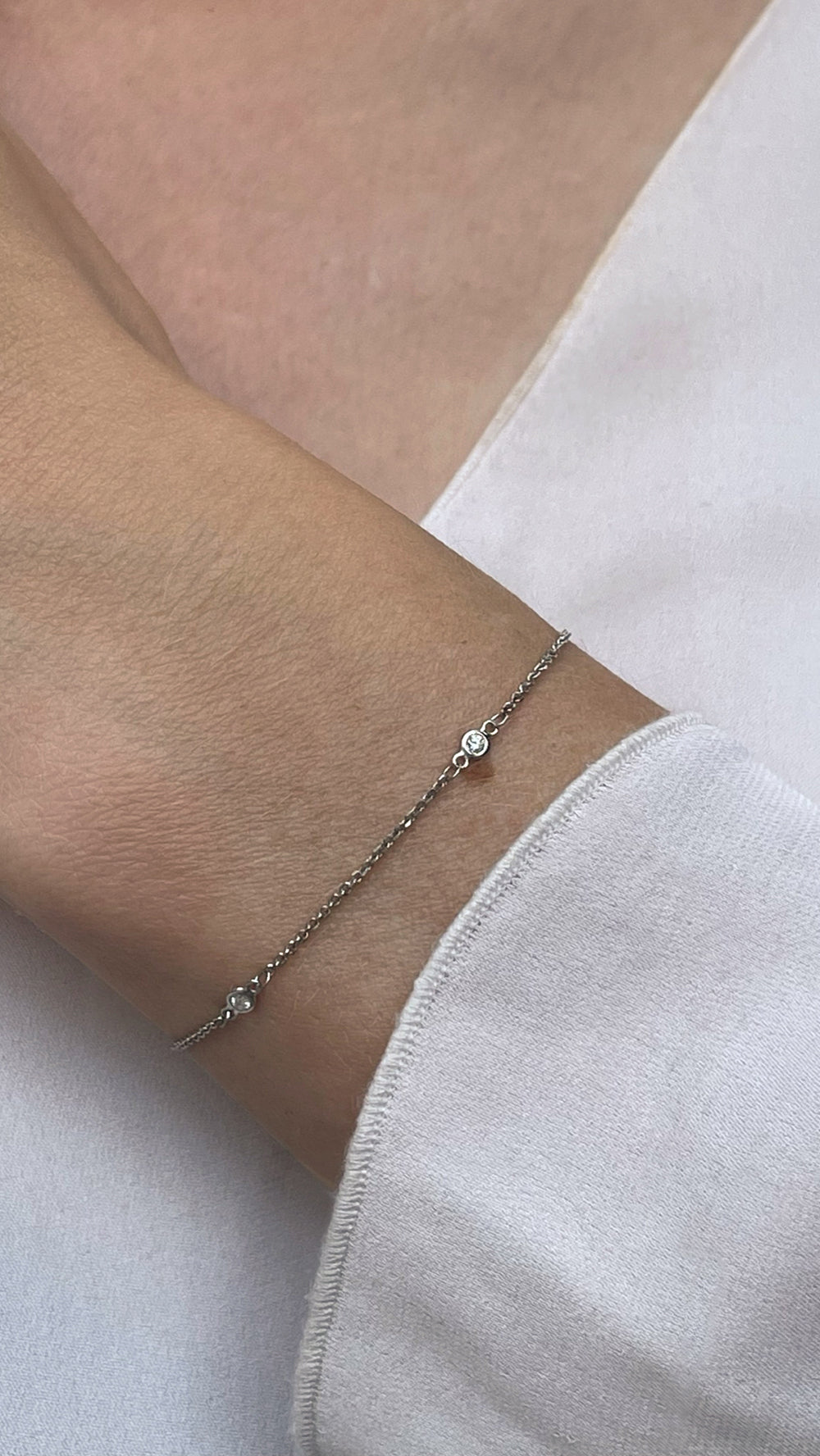 White Gold and Diamond Station Bracelet with Bezel Set Round Brilliant Cut Diamonds