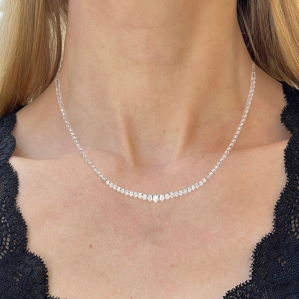 White gold graduated diamond necklace, modeled by a blonde woman in a black lace blouse