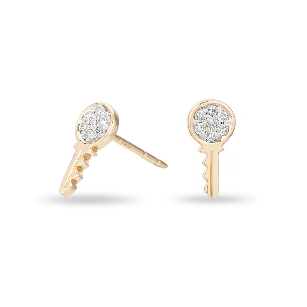 A pair of small yellow gold key post earrings with pavé diamond accents.