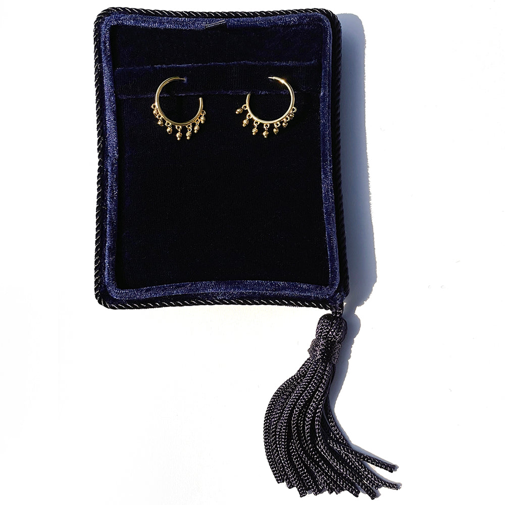 14K Yellow Gold open hoop beaded earrings with dangling diamond-cut bead accents shown in a jewelry box