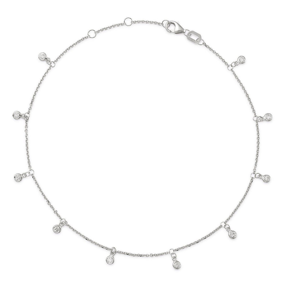 A white gold chain anklet with bezel-set diamonds dangling from the chain.