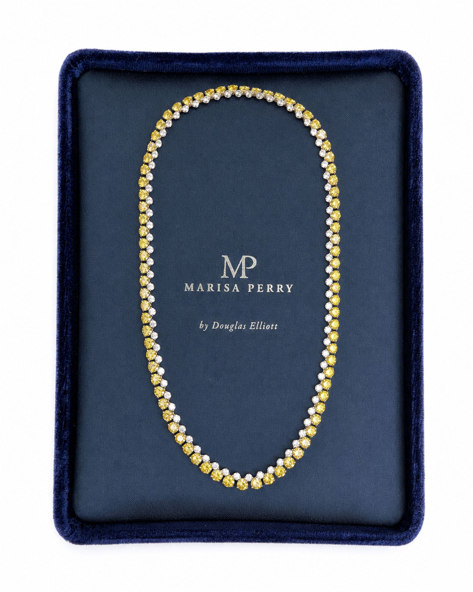 Alternating white and yellow diamond tennis necklace featuring natural round brilliant diamonds in 18K white and yellow gold displayed in a Marisa Perry jewelry box.