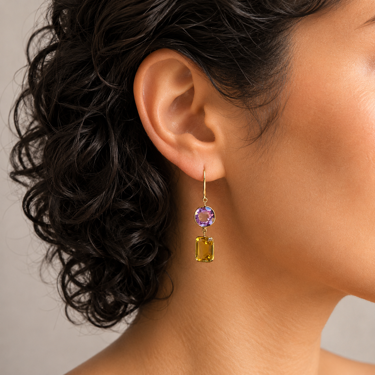 A model wearing Amethyst and Citrine drop earrings.