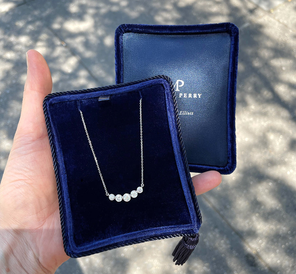 Bezel Set Diamond Curved Bar Necklace in 14K white gold (0.80 TCW) displayed in a Marisa Perry jewelry box.
