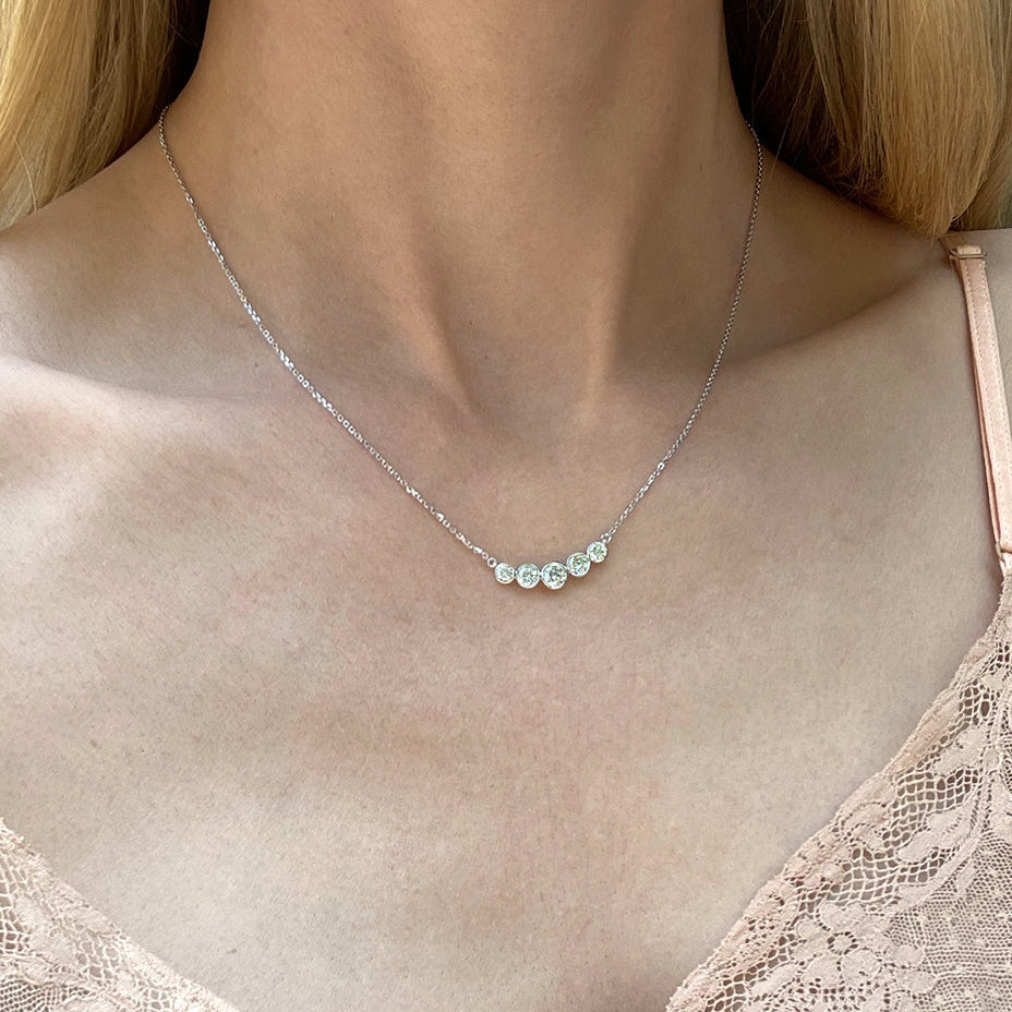 Model wearing the Bezel Set Diamond Curved Bar Necklace in 14K white gold (0.80 TCW).