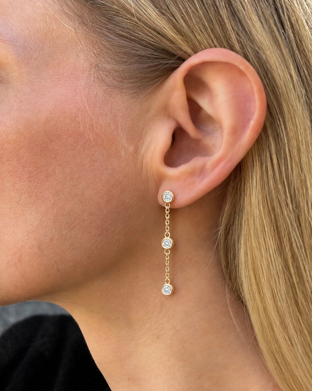 Bezel Set Diamond Drop Earrings in 14K yellow gold featuring three round brilliant-cut diamonds suspended along each delicate cable chain.