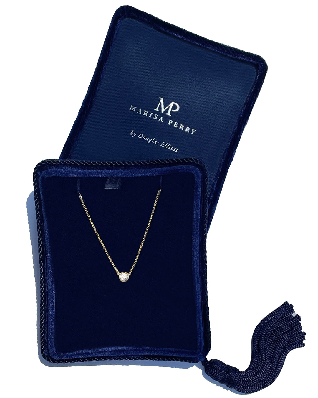 A delicate 14k yellow gold chain necklace with a 0.25 carat round brilliant-cut diamond bezel set pendant, displayed inside a dark navy velvet jewelry box with a tassel.