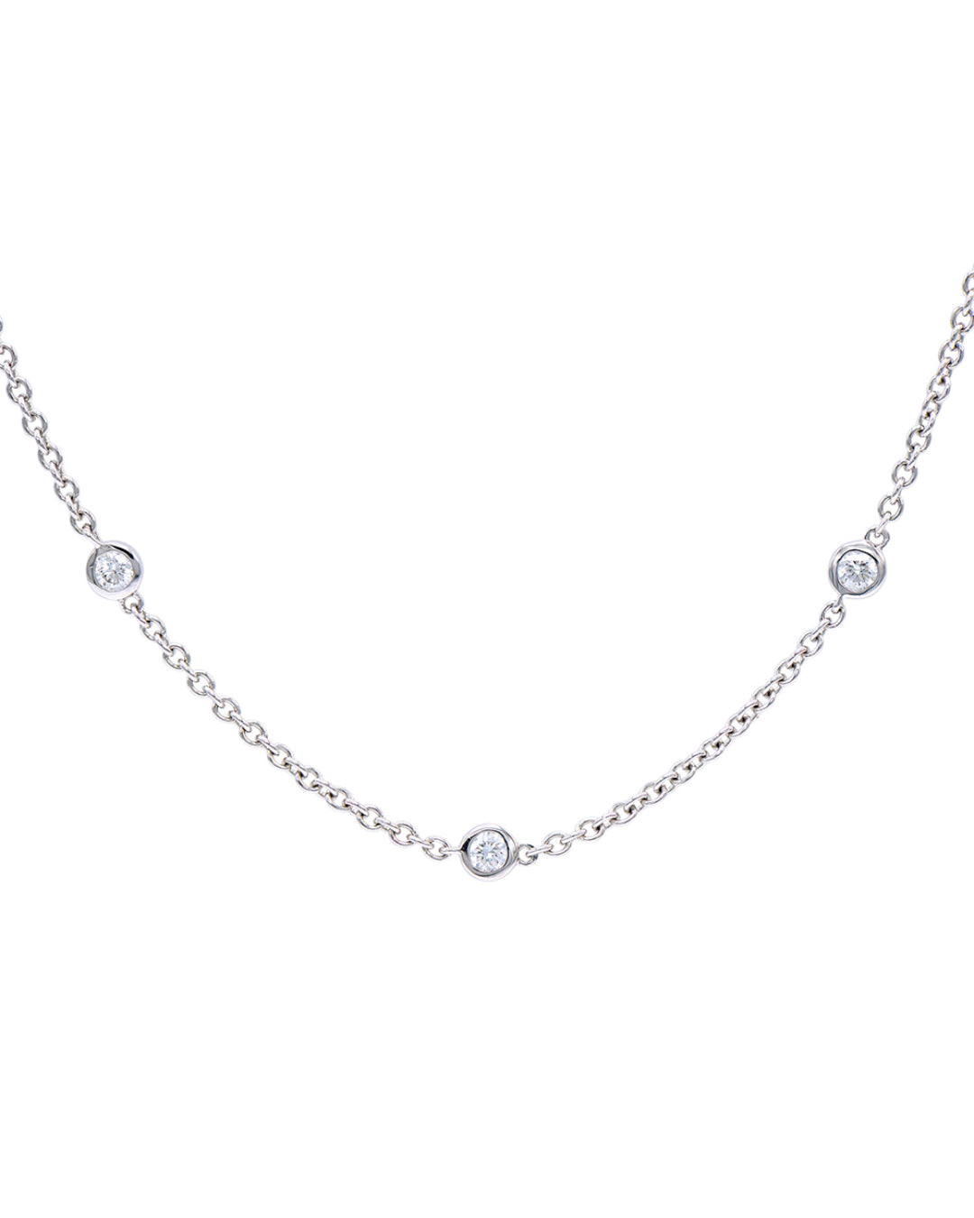 Close-up of five-station diamond bracelet in 14K white gold, highlighting three bezel-set diamonds and the delicate chain.
