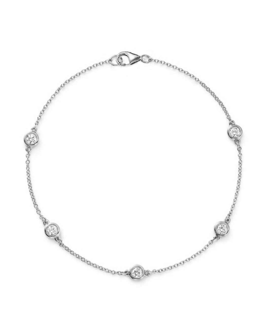 14K white gold diamond station bracelet featuring five bezel-set round brilliant-cut diamonds along a delicate chain.
