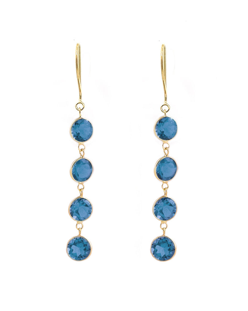 A pair of 18K yellow gold earrings featuring four London Blue Topaz stones each, arranged in a vertical line, creating a drop earrings design.