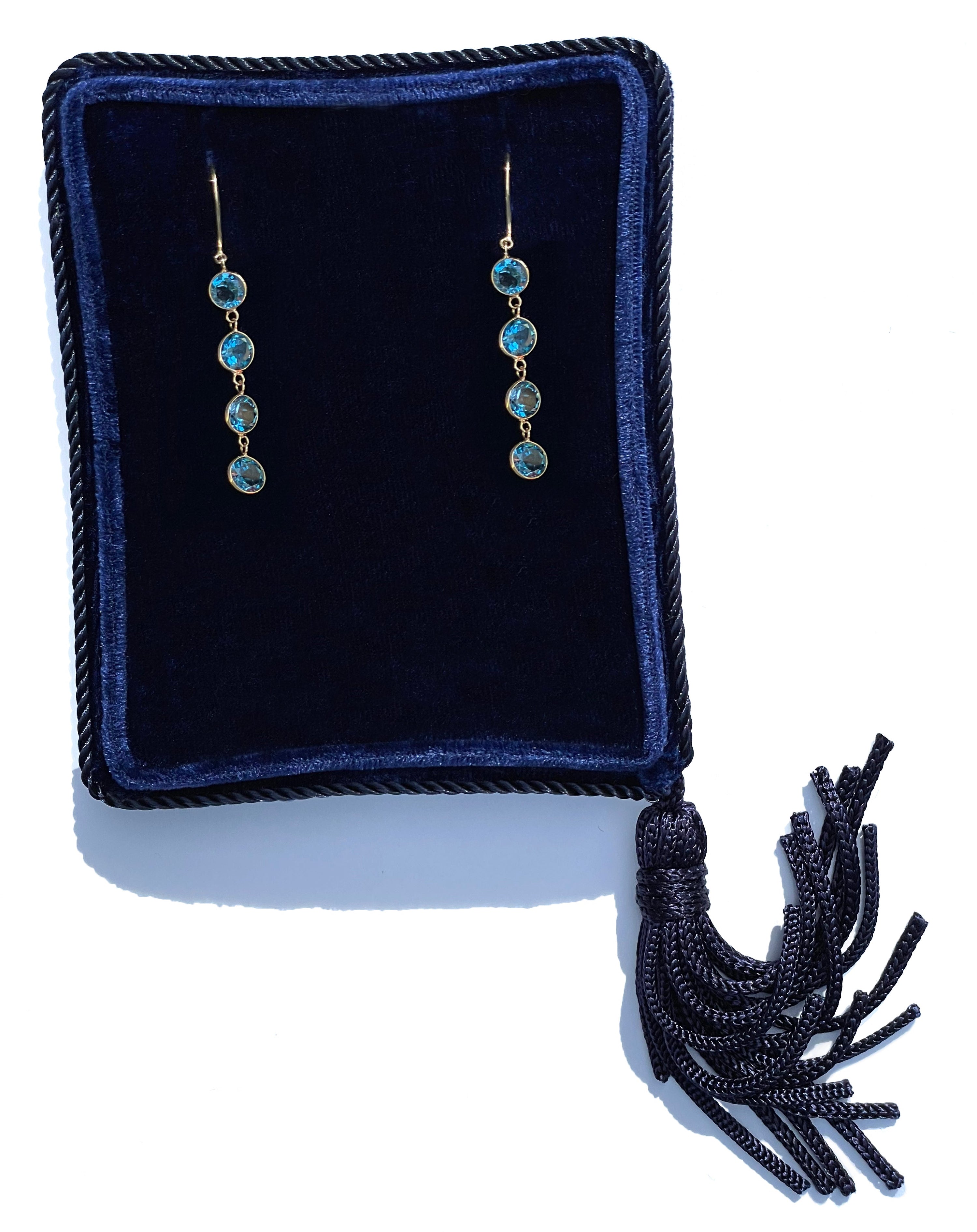Four stone London blue topaz drop earrings in a navy blue velvet Marisa Perry jewelry box.