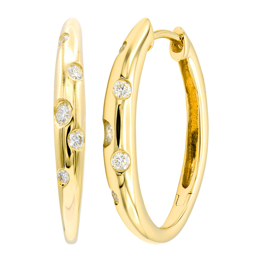 A pair of 14K yellow gold diamond hoop earrings with scattered burnished diamonds throughout the front.