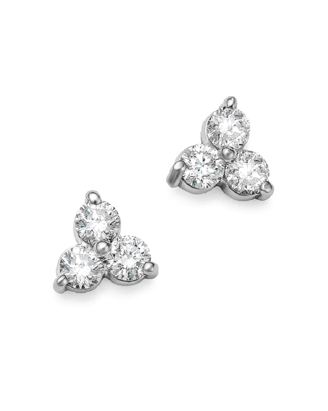 A pair of medium-sized white gold trilogy stud earrings, featuring three round brilliant cut diamonds.