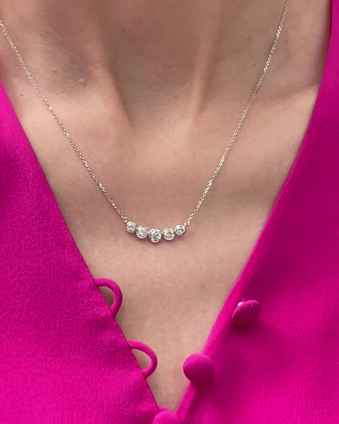 Model wearing the Bezel Set Diamond Curved Bar Necklace in 14k white gold (0.80 TCW), with the camera slowly zooming in to highlight the five bezel set diamonds.