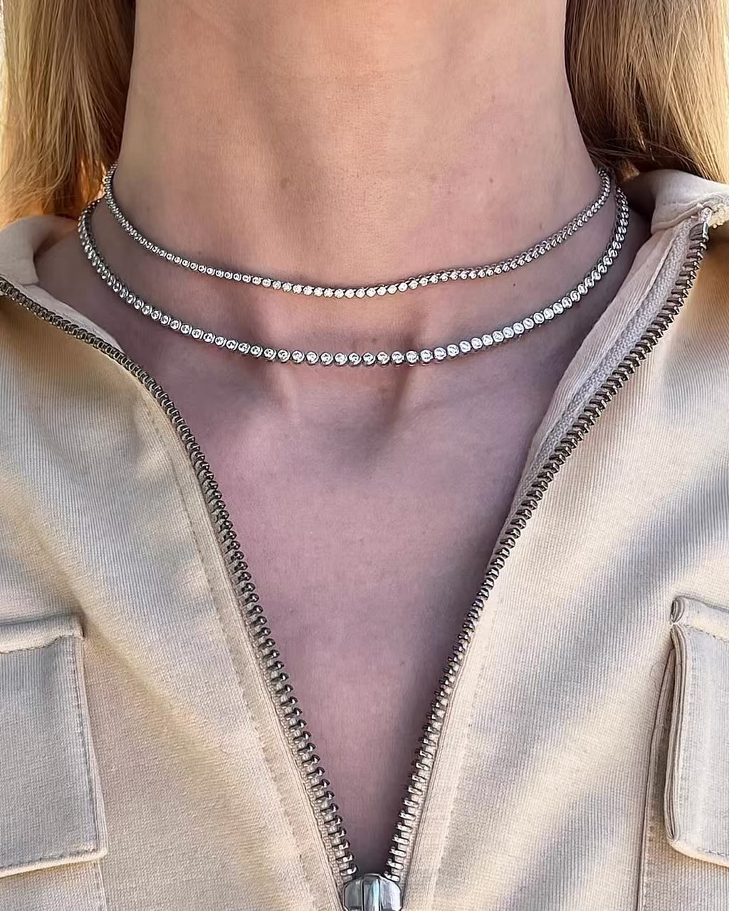 A model turning slowly, comparing the 1.88 TCW and 4.71 TCW Bezel Set Diamond Tennis Necklaces.