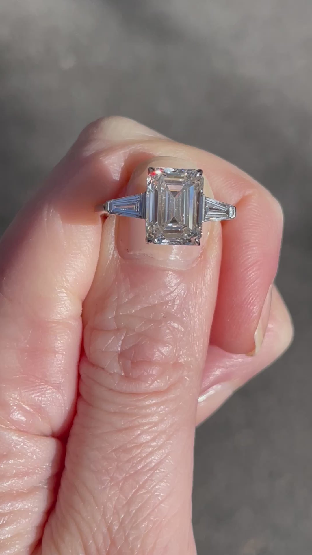 3.53 Carat Emerald Cut Diamond Three Stone Engagement Ring with Tapered Baguettes | Marisa Perry by Douglas Elliott_A26176_Video2