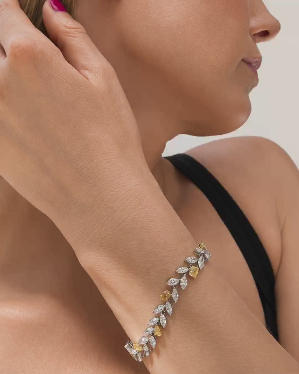 Mixed shape white and yellow diamond bracelet shown on a model's wrist, followed by close-up views of the bracelet and Marisa Perry jewelry box.