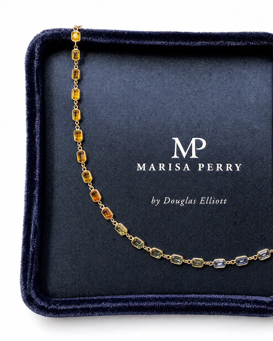 Rainbow sapphire bezel set necklace displayed in a Marisa Perry jewelry box.