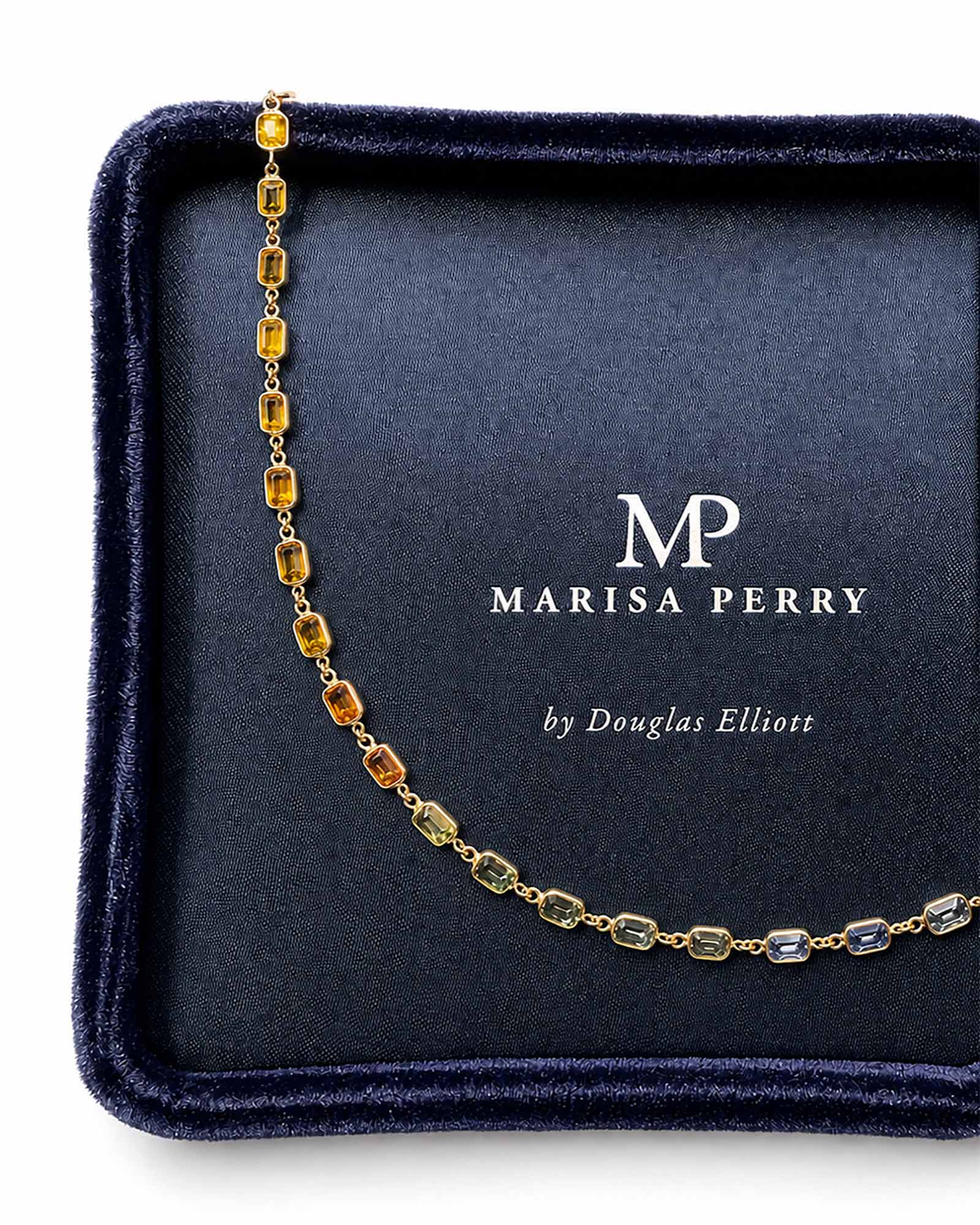 Rainbow sapphire bezel set necklace displayed in a Marisa Perry jewelry box.