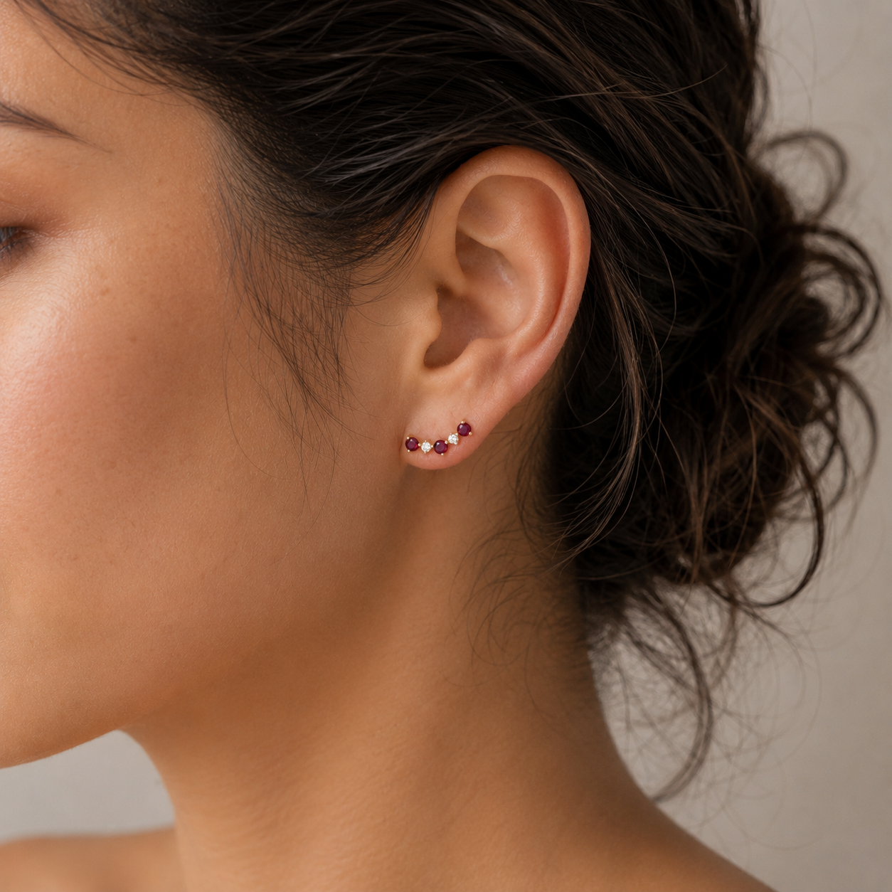 model wearing ruby and diamond cluster stud earrings