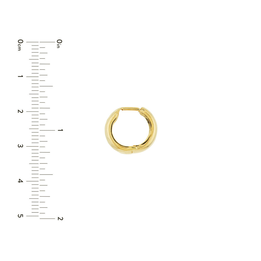 Size reference of yellow gold textured wide huggie hoop earrings.